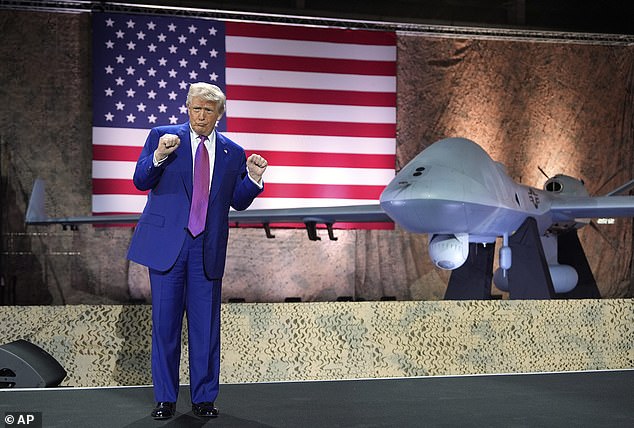 President Donald Trump does the 'Trump Dance' backdropped by an MQ-9 Reaper drone at the Al Udeid Air Base