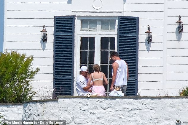 Swift and her boyfriend Travis Kelce (right), alongside Patrick Mahomes (left) were seen at the house last summer (pictured)