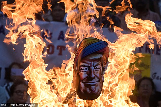 Activists from India's Congress party burn an effigy of US President Donald Trump for what they claim to be his interference in the India-Pakistan conflict, during a protest in Kolkata on May 14, 2025