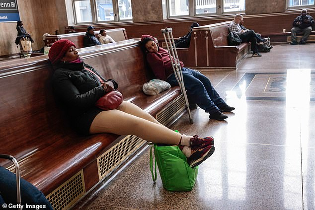Passengers sit a the waiting area during a NJ Transit Railroad Engineers Strike at Newark Penn Station in New Jersey on May 16, 2025