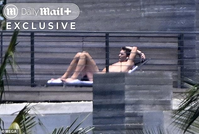 The sports veteran stretched out on his rooftop during the day