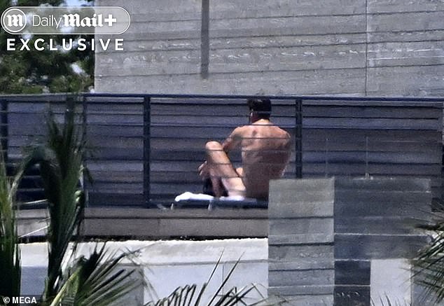 Brady is seen sunbathing on his deck in Miami