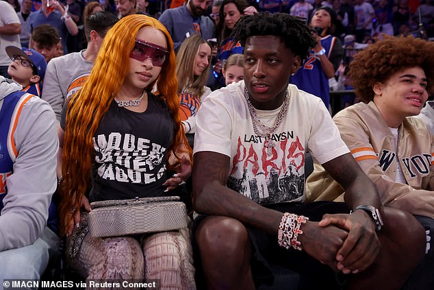 Rapper Ice Spice (L) and New York Jets cornerback Sauce Gardner (R) watch courtside