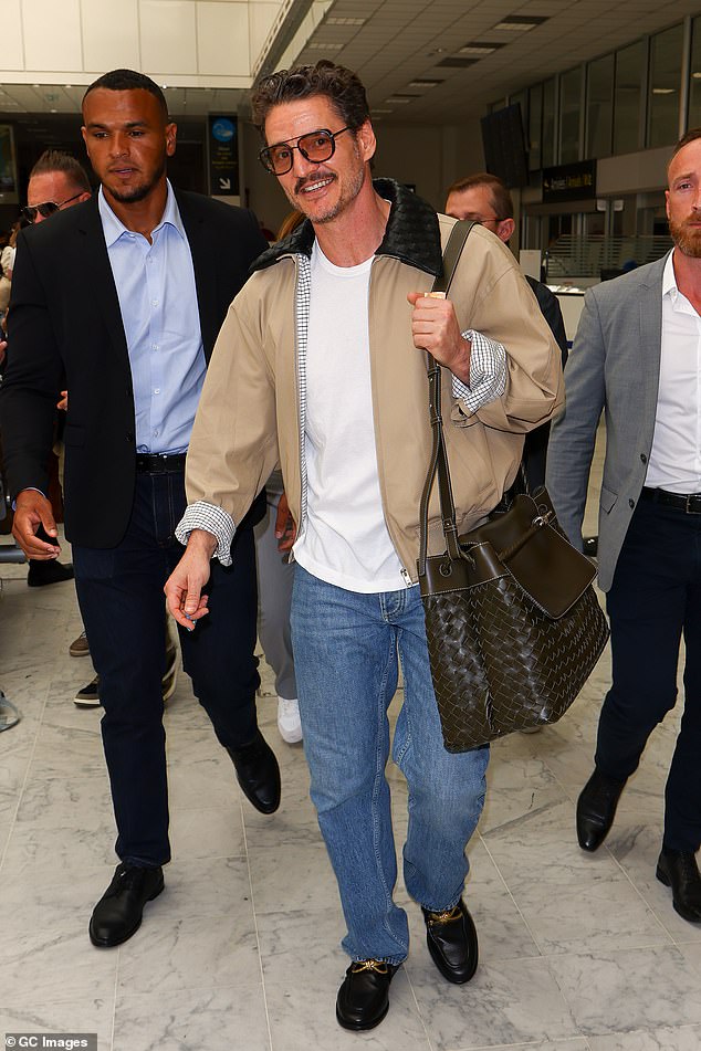 The Narcos star looked effortlessly cool in a head-to-toe Bottega Veneta travel look, including a $3,300 khaki jacket with the luxury house's signature woven leather collar