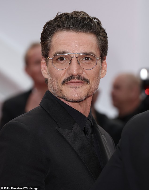 He looked elegant in a black suit and eyeglasses