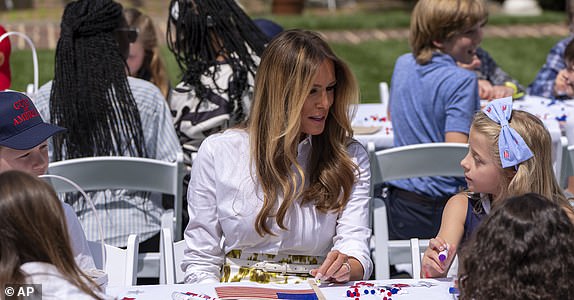 First lady Melania Trump participates in flag decorating during a Take Our Child to Work Day event in the Jacqueline Kennedy Garden at the White House, Tuesday, May 20, 2025, in Washington. (AP Photo/Alex Brandon)