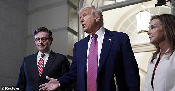 U.S. President Donald Trump and U.S. House Speaker Mike Johnson (R-LA) speak to members of the media, on the day of a closed House Republican Conference meeting on Capitol Hill in Washington, D.C., U.S., May 20, 2025. REUTERS/Ken Cedeno