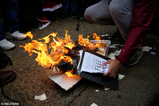 Extraordinary photographs from the protest captured students setting fire to their own diplomas after pouring years of effort and thousands of dollars into achieving the certificate