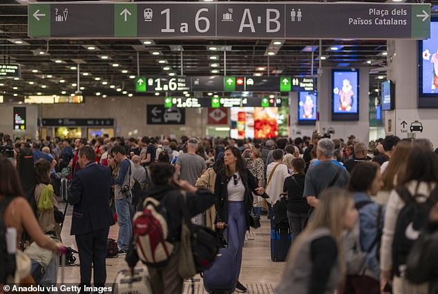 Stranded passengers wait with their luggage at Sants Station in Barcelona amid a power outage in April that caused mass disruption to travel