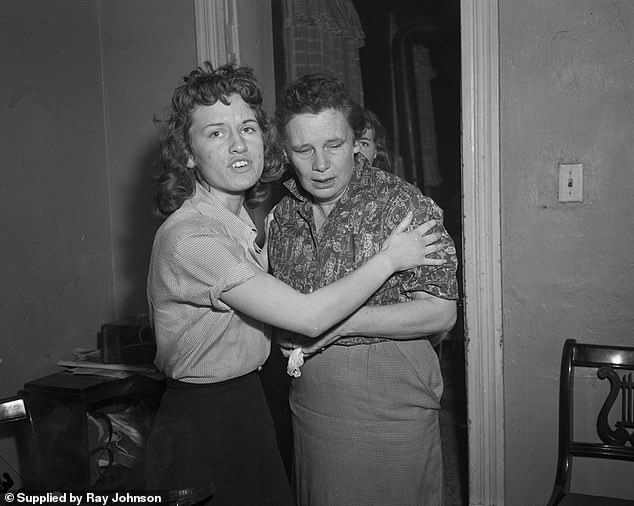 Loretta Grimes is seen being comforted by another of her daughters. She maintained until her death that the mystery caller killed Barbara and Patricia