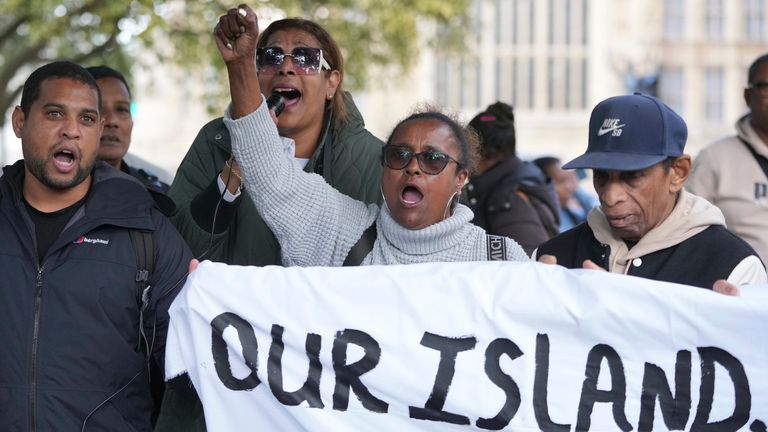 Chagossians attend a protest to response the U.K. announcement to agree to hand sovereignty of the long-contested Chagos Islands to Mauritius and against their "Exclusion" from Chagos negotiations, outside the House of Parliament, in London, Monday, Oct. 7, 2024. (AP Photo/Kin Cheung)