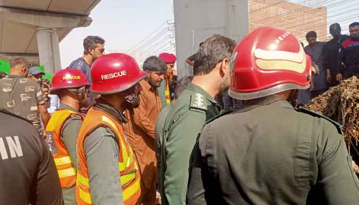 Rescue officials can be seen at the site of dumper truck accident in  Lahore. — Geo News