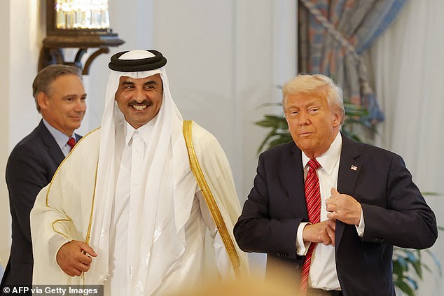 Qatar's Emir Sheikh Tamim bin Hamad al-Thani (L) and US President Donald Trump leave after a signing ceremony at the Royal Palace in Doha on May 14, 2025