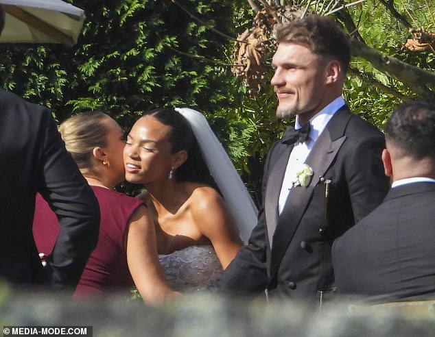 Footy star Angus Crichton (right) has married Chloe Esegbona (second from right) in a lavish New South Wales ceremony