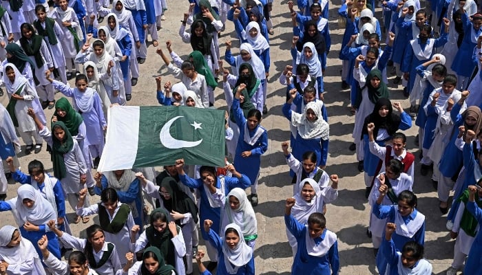 Students salute as they express solidarity with Pakistans armed forces during a school assembly in Lahore on May 12, 2025. — AFP