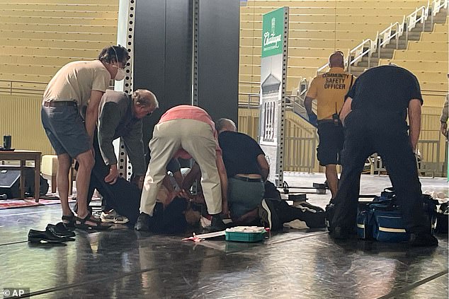 Author Salman Rushdie is tended to after he was attacked during a lecture, Aug. 12, 2022, at the Chautauqua Institution in Chautauqua, New York