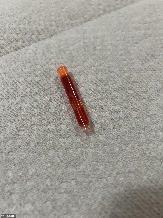 A homeowner was left baffled after discovering a 'strange' plastic tube filled with orangish liquid in their living room