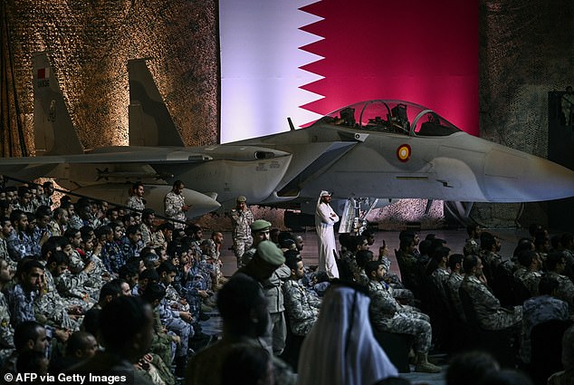 US and Qatari troops and staff await President Donald Trump