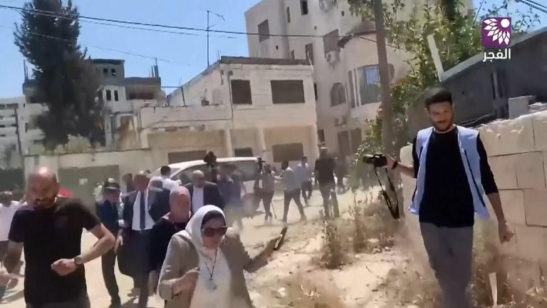 Members of the delegation flee as gunshots are fired