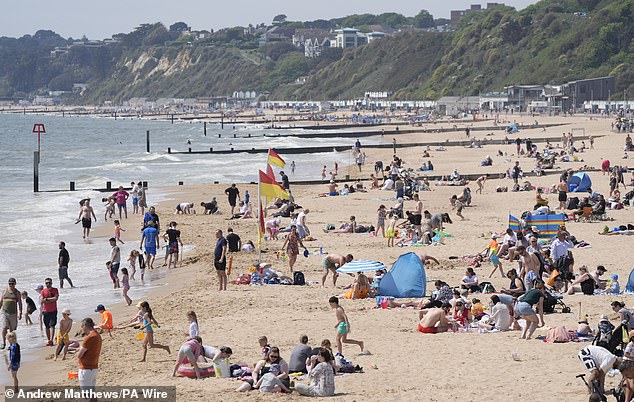 Swimmers have flocked to the beaches around the UK and Ireland as an 'extreme marine heatwave' sends temperatures soaring up to 4°C (7.2°F) above usual