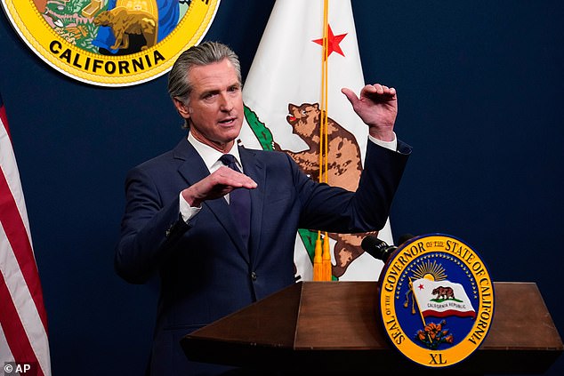 Gavin Newsom (pictured) is putting new conditions on a program offering healthcare to illegal migrants as the state continues to face a budget crisis, though he claims its Donald Trump's fault