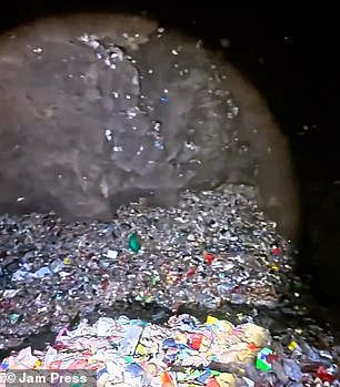 The cave is filled with huge piles of litter, including plastic bottles and wrappers