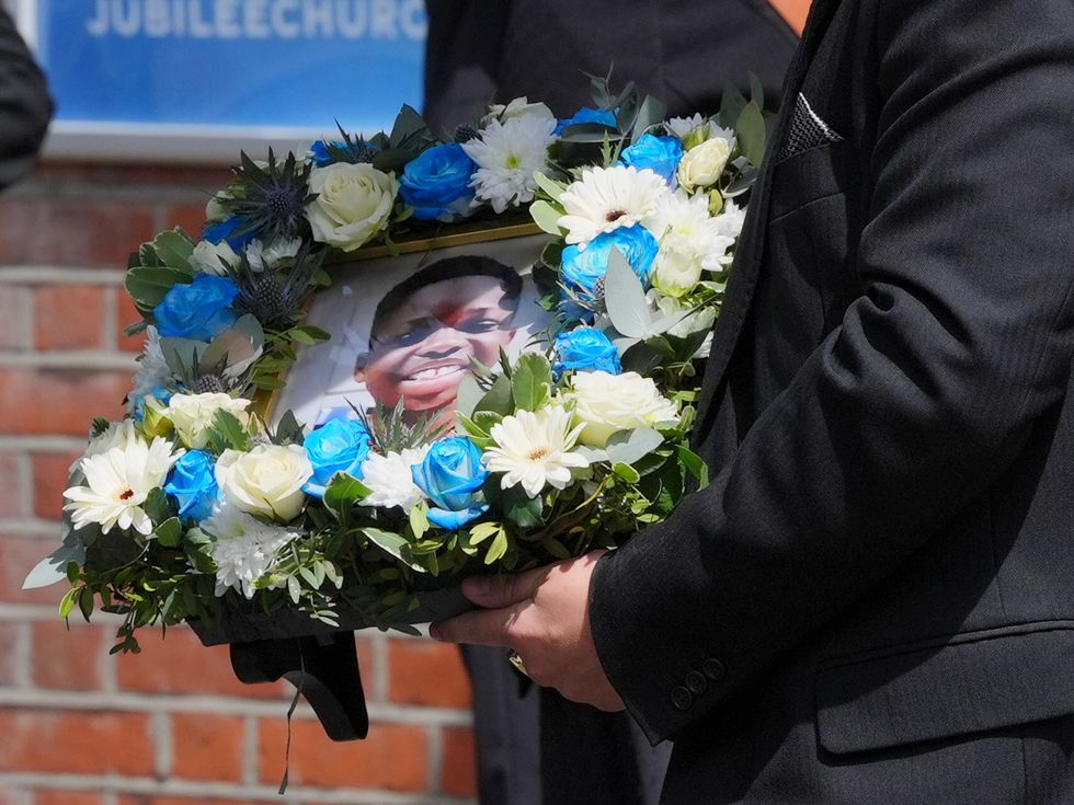 Mourners carry a portrait of Daniel Anjorin at the 14-year-old's funeral