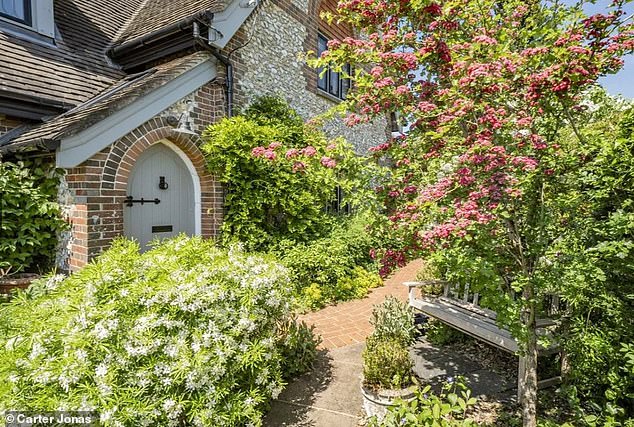 Welcoming: The entrance to Woodlands Chapel is laden with flowers, trees and shrubs