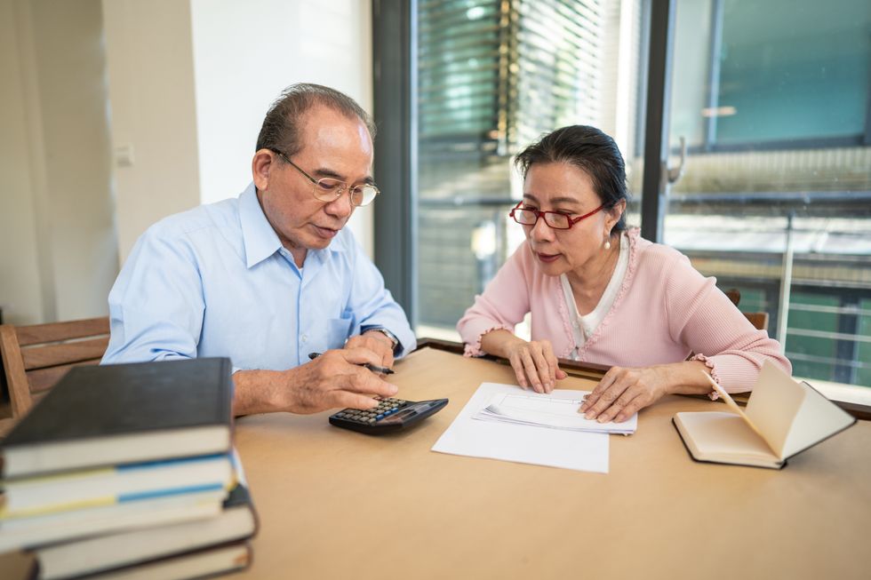 Pension savers look at calculator and documents