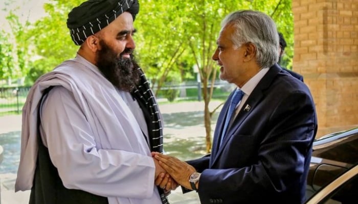 Acting Foreign Minister of Afghanistan Amir Khan Muttaqi (left) shakes hands with Deputy Prime Minister and Foreign Minister Senator Ishaq Dar. — APP/File
