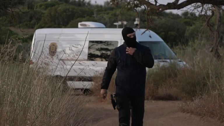 A police officer wearing a balaclava in Praia da Luz - where authorities are searching for Madeleine McCann