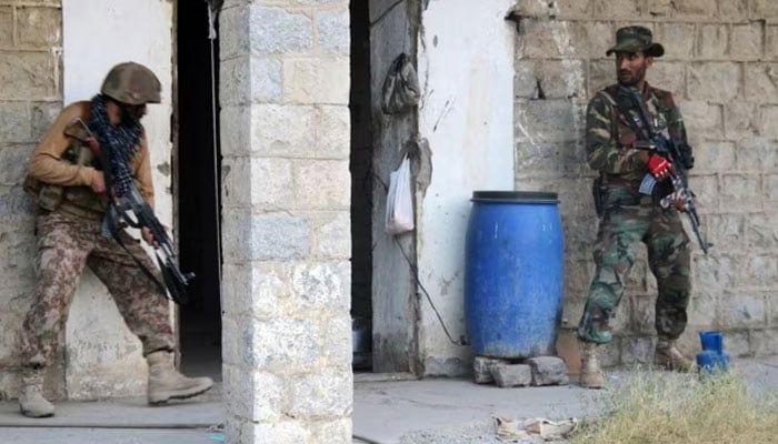 Pakistani Army soldiers take position as they search a house during a military operation against terrorists in North Waziristan. — AFP/File