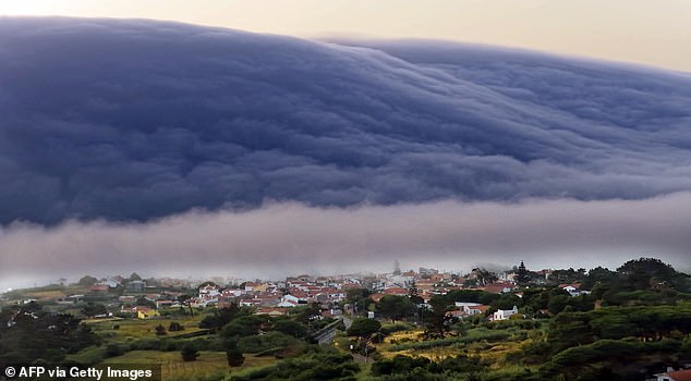 PORTUGAL: A rare 'roll cloud' advancing from the horizon towards the beaches of the Atlantic Ocean during the heatwave near Cabo da Roca, southwestern Portugal, on Sunday