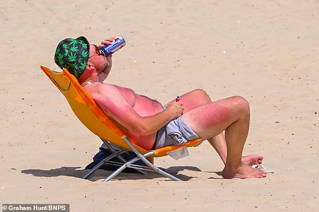 Europe has seen record-breaking temperatures this week, as a deadly heatwave sweeps the continent. Pictured: a sunbather on the beach in Dorset