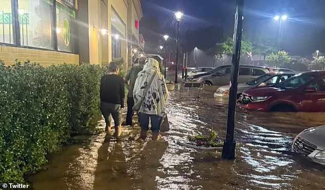 The storm unleashed up to 10 inches of rain across central North Carolina on Sunday (pictured), inundating homes, submerging roads and stranding numerous drivers