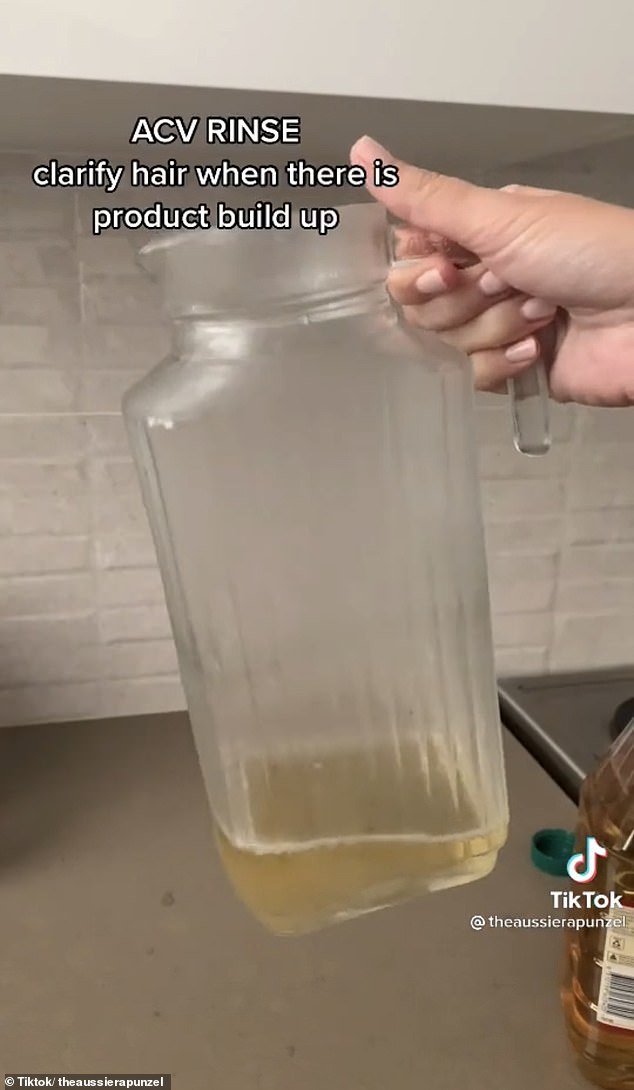 First she poured a small amount of apple cider vinegar into an empty jug (pictured)