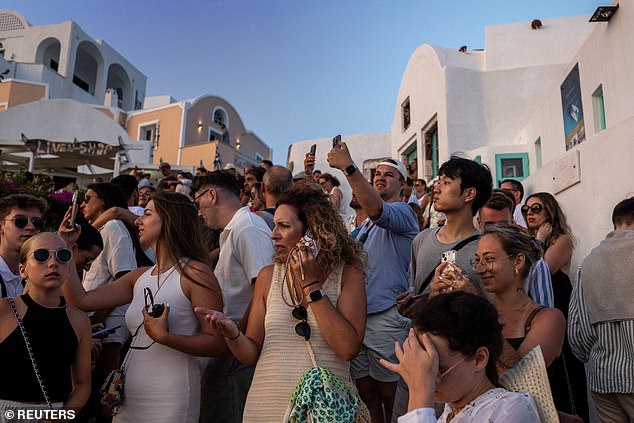 Claire, who had travelled more than 9,000 miles from Sydney, Australia described Oia as synonymous with 'animalistic mayhem', adding that that the relentless torrent of holidaymakers had left it 'crowded and jam packed'. Pictured: scores of tourists in Santorini on July 25, 2024