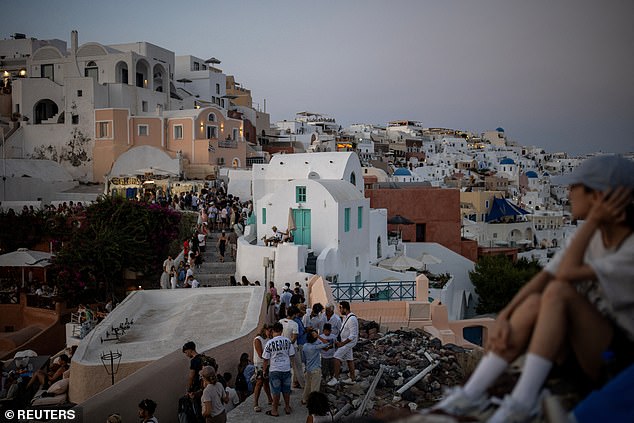 Some locals in Oia have even resorted to putting signs up urging visitors to respect their home, with one sign from the Save Oia group reading: 'RESPECT... It's your holiday... but it's our home'