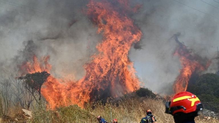 Firefighters try to extinguish flames as a wildfire burns on the island of Kythira, Greece, July 26, 2025. REUTERS/Stamatina Tamvaki
