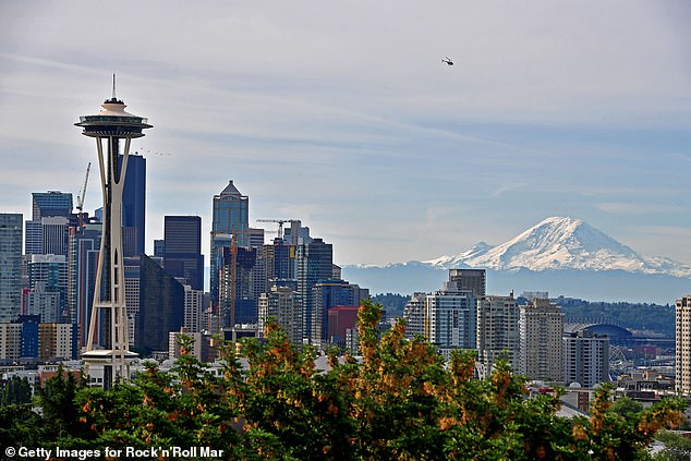 Mount Rainier (right) sits dangerously close to major US cities like Seattle (pictured), which has a population of more than 750,000