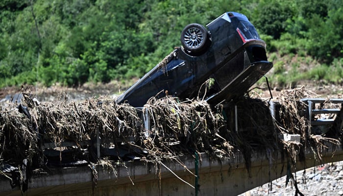 This representational image shows a flood-damaged car following heavy rains over the past few days in the Huairou district, on the outskirts of Beijing, on July 30, 2025. — AFP