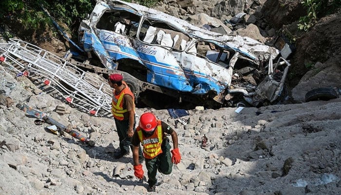 Representational image shows rescue personnel inspecting the site of a bus accident that killed 23 people after it plunged into a ravine at Soon village near Kahuta, Punjab province on August 25, 2024. — AFP/File