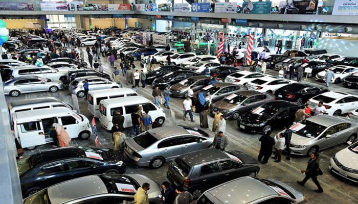 Customers look at cars on sale during an event in this undated file photo. — APP