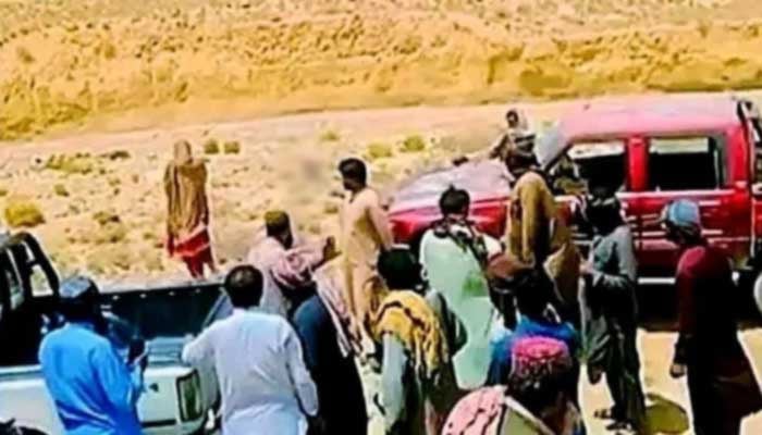 Screengrab of viral video shows tribal members carrying out honour killing at unknown location in Balochistan. — X
