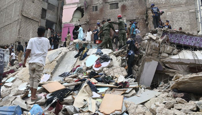 Rescue workers search for victims under the rubble after a five-story residential building collapsed in Karachi on July 04, 2025. — Online