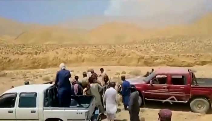 Screengrab of viral video shows tribal members carrying out “honour killing” at unknown location in Balochistan. — X