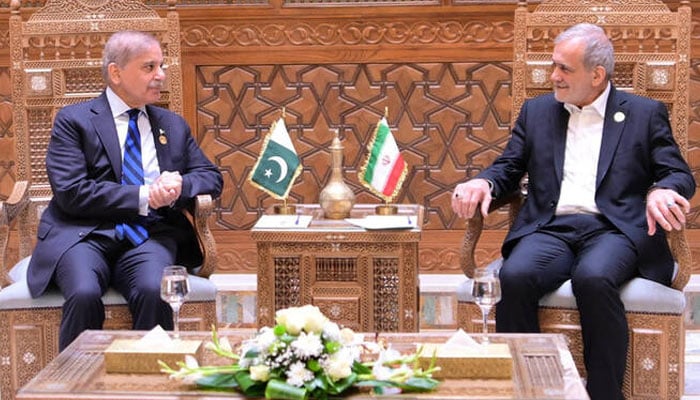 Prime Minister Shehbaz Sharif meets Iranian President Masoud Pezeshkian (right) on the sidelines of the 11th D-8 Summit in Cairo, Egypt, on December 19, 2024. — APP