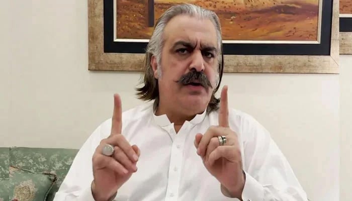 KP CM Ali Amin Gandapur gestures during a video link address to PTI workers. — Screengrab via Geo News/File