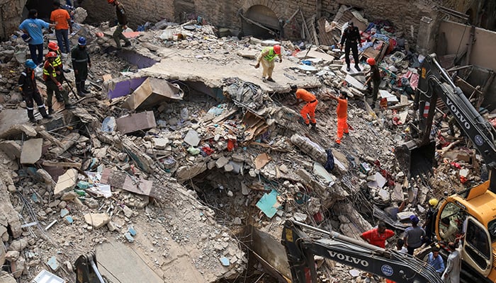Rescue workers search for survivors as they go through the rubble of a five-storey residential building, which collapsed in Karachi, on July 4, 2025. — Reuters
