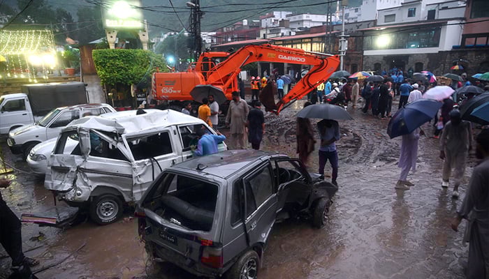 A view of damaged cars being recovered from a nullah in Saidpur Village due to flooding caused by heavy rainfall in the Islamabad. — APP/File